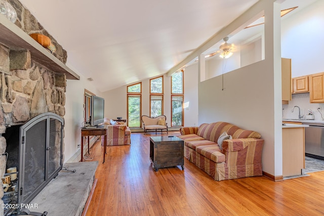 20 Clemen V Muller St, Beach Lake, PA 18405 - living room with high vaulted ceiling, a stone fireplace, light wood-style flooring, and a ceiling fan