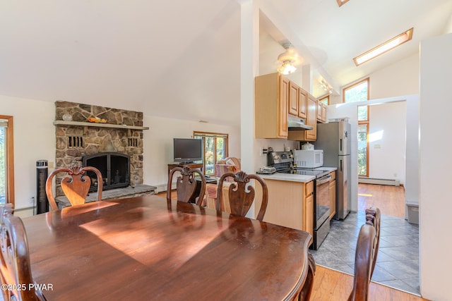 20 Clemen V Muller St, Beach Lake, PA 18405 - dining space with vaulted ceiling, a baseboard heating unit, a fireplace, and light tile patterned floors