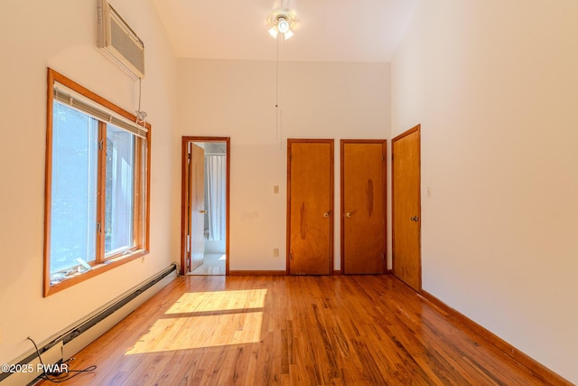 20 Clemen V Muller St, Beach Lake, PA 18405 - spare room featuring a baseboard radiator, wood finished floors, and a towering ceiling