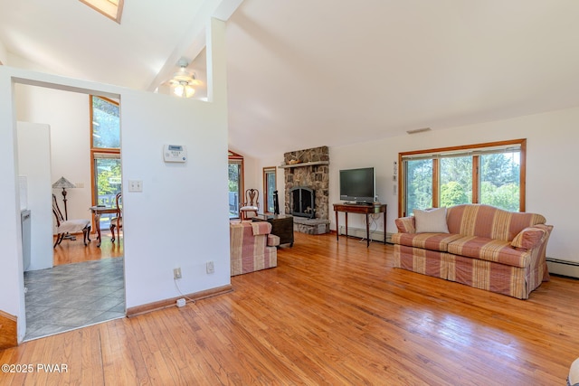 20 Clemen V Muller St, Beach Lake, PA 18405 - living area featuring a fireplace, light wood finished floors, vaulted ceiling, healthy amount of natural light, and a baseboard radiator