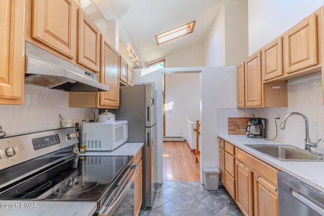 20 Clemen V Muller St, Beach Lake, PA 18405 - kitchen featuring stainless steel appliances, under cabinet range hood, vaulted ceiling, light brown cabinetry, and a baseboard radiator