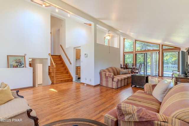 20 Clemen V Muller St, Beach Lake, PA 18405 - living area with wood finished floors, healthy amount of natural light, track lighting, high vaulted ceiling, and stairway