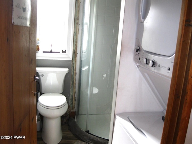 bathroom with toilet and a shower with door