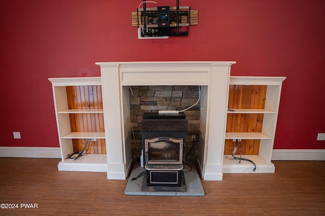 details featuring hardwood / wood-style flooring and a wood stove