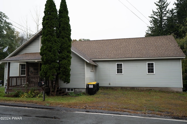 view of property exterior featuring a porch