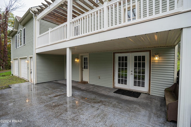 view of patio featuring a garage and french doors