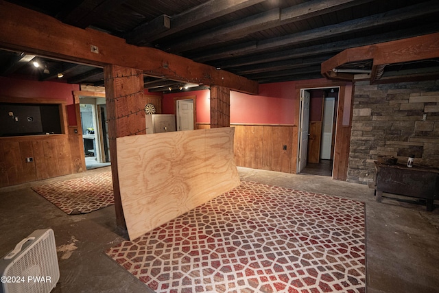 basement featuring wood walls