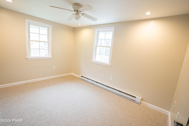 spare room with ceiling fan, carpet floors, and a baseboard radiator