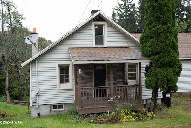 back of property featuring a porch