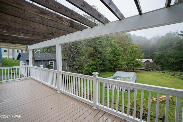 deck with a pergola and a lawn