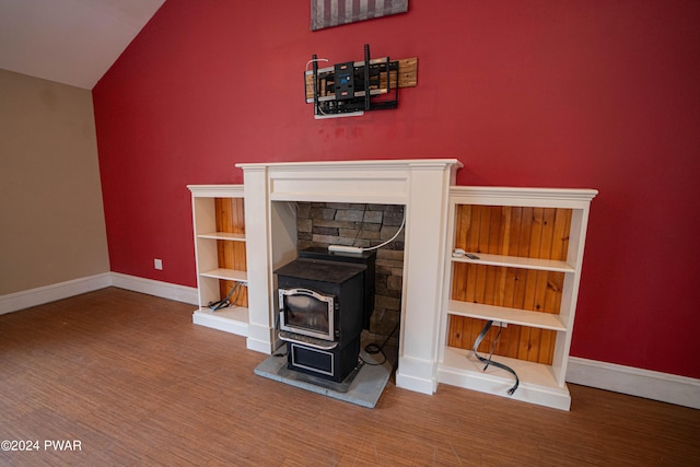 interior details with a wood stove and hardwood / wood-style flooring