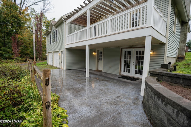 view of patio featuring a garage and french doors