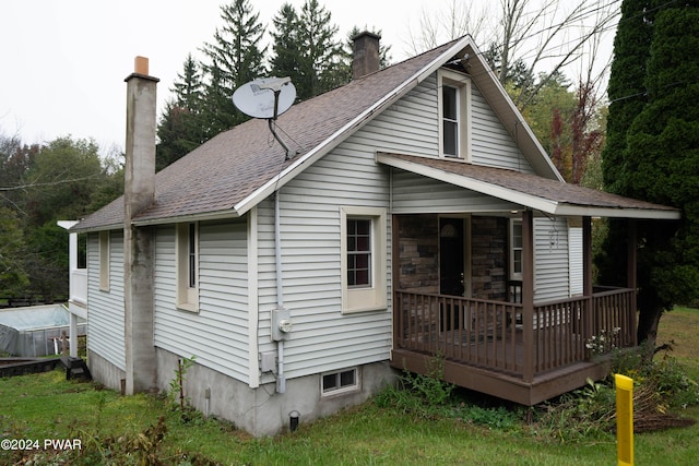 rear view of house featuring a wooden deck