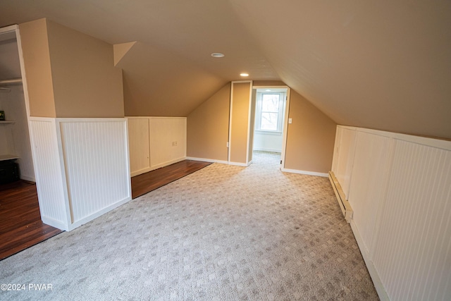 bonus room featuring carpet, vaulted ceiling, and baseboard heating