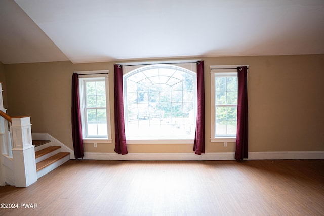 interior space featuring light hardwood / wood-style floors and vaulted ceiling