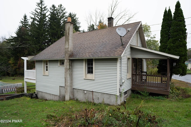 rear view of property featuring a lawn