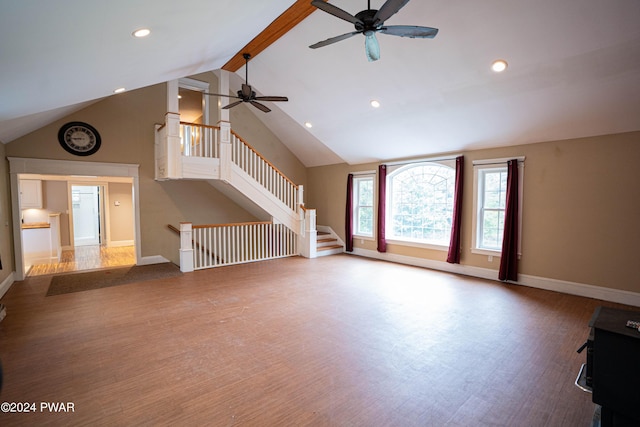 unfurnished living room with wood-type flooring, lofted ceiling with beams, and ceiling fan