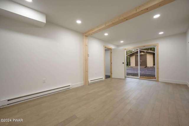 spare room featuring light hardwood / wood-style floors and a baseboard heating unit