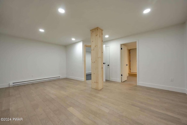 basement with a baseboard radiator and light wood-type flooring