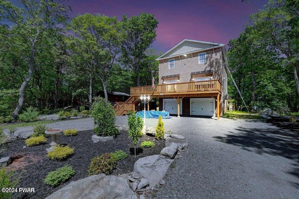 view of property with a garage and a deck