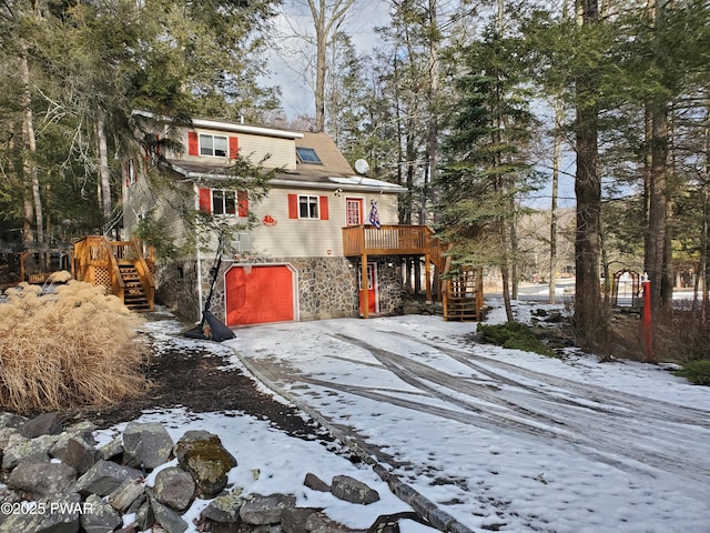 view of front of home with a wooden deck and a garage