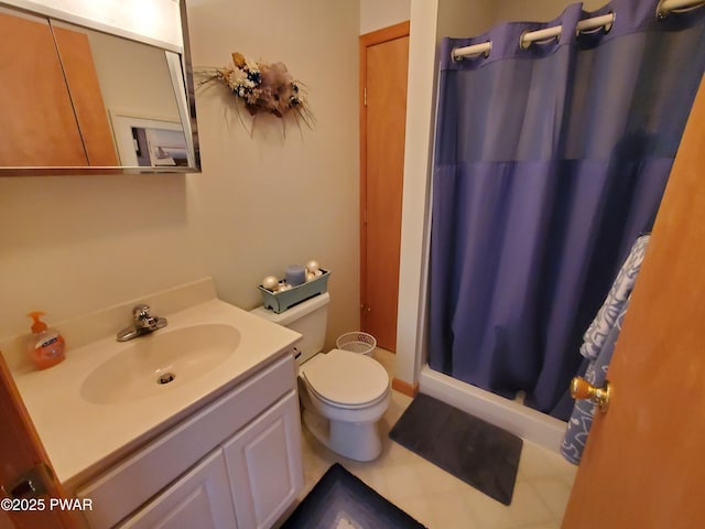 bathroom with vanity, toilet, and walk in shower