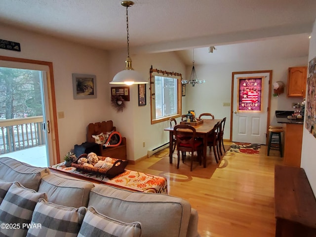 living room with baseboard heating and light wood-type flooring