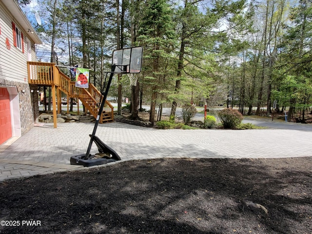 view of sport court featuring stairway