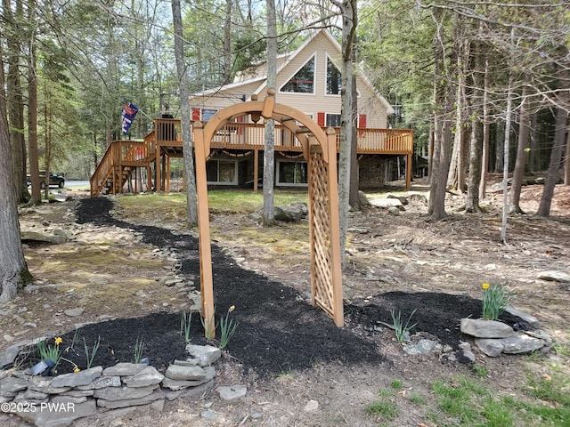 view of yard with a deck and stairs
