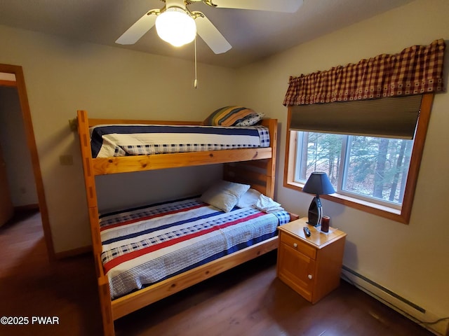 bedroom with dark hardwood / wood-style floors, ceiling fan, and baseboard heating