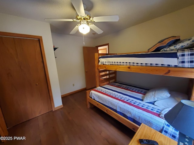 bedroom with dark wood-type flooring and ceiling fan