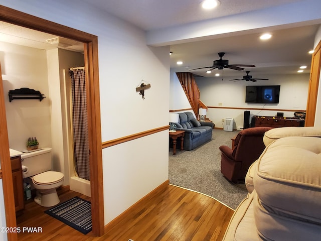 living room with hardwood / wood-style floors and ceiling fan