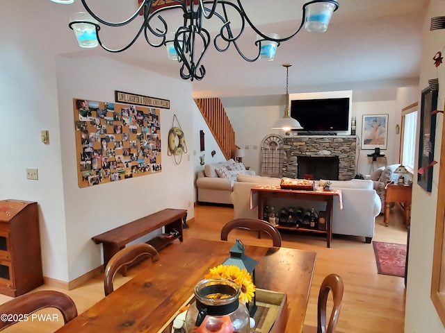 dining area featuring a fireplace and light hardwood / wood-style floors