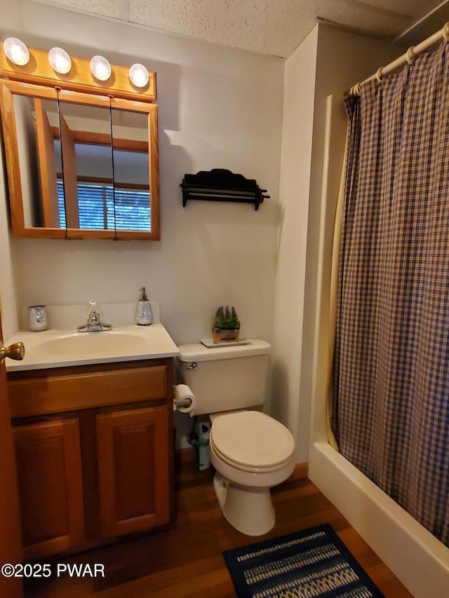 bathroom featuring vanity, a shower with curtain, wood-type flooring, and toilet