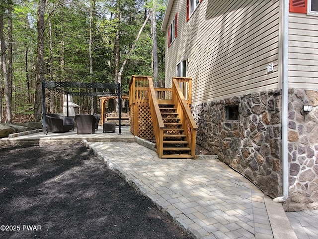 exterior space featuring a wooden deck, stairs, and an outdoor living space