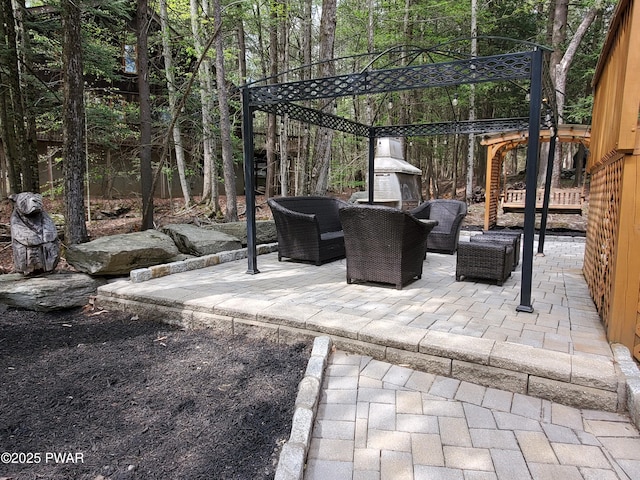 view of patio featuring a fenced backyard and an outdoor living space with a fireplace