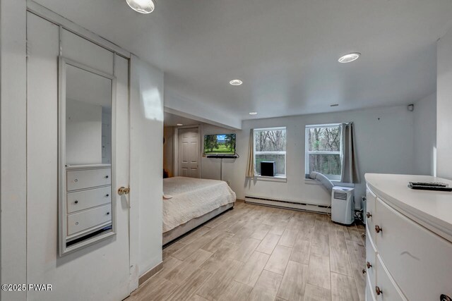 3218 Bluebird Dr, Bushkill, PA 18324 - bedroom with a baseboard radiator, light wood-style floors, and recessed lighting