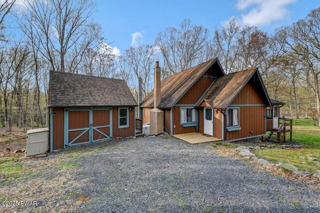 3218 Bluebird Dr, Bushkill, PA 18324 - rustic home with a chimney and a shingled roof