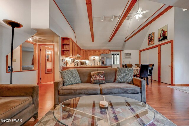 3218 Bluebird Dr, Bushkill, PA 18324 - living room with light wood-type flooring, high vaulted ceiling, a ceiling fan, track lighting, and a wall mounted AC