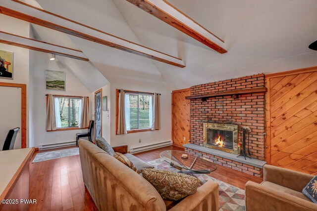 3218 Bluebird Dr, Bushkill, PA 18324 - living room featuring baseboard heating, a fireplace, hardwood / wood-style flooring, and wood walls