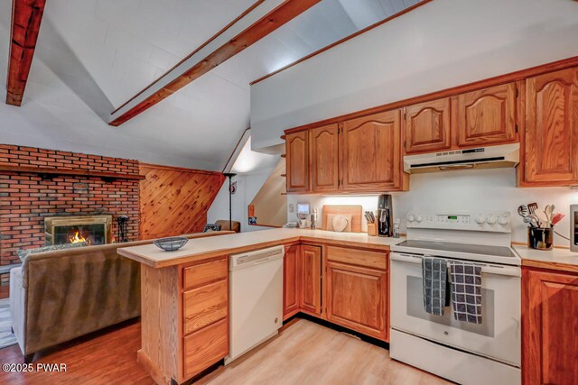 3218 Bluebird Dr, Bushkill, PA 18324 - kitchen with under cabinet range hood, white appliances, a peninsula, and light wood finished floors