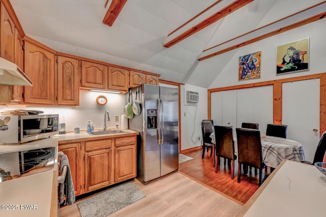 3218 Bluebird Dr, Bushkill, PA 18324 - kitchen featuring a sink, stainless steel appliances, beam ceiling, light countertops, and light wood finished floors