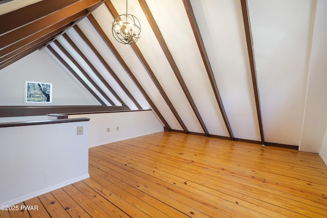 additional living space with vaulted ceiling with beams, light wood-type flooring, and a chandelier