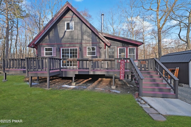 back of property with stairs, a lawn, and a wooden deck