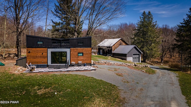 view of outbuilding featuring a lawn and a garage