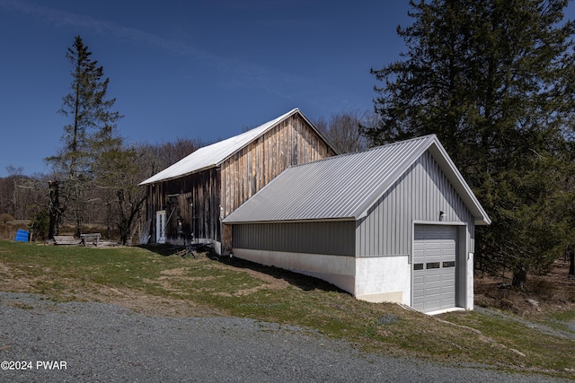 exterior space featuring a garage and an outdoor structure