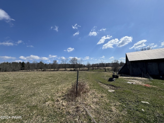 view of yard featuring an outbuilding and a rural view