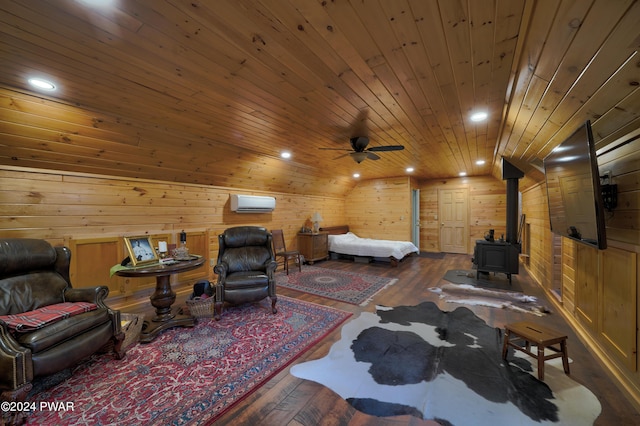 sitting room with a wood stove, ceiling fan, dark wood-type flooring, and wooden ceiling