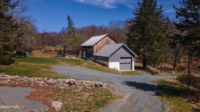 view of side of property with a garage and an outdoor structure