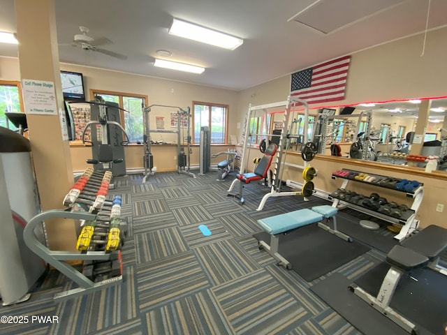 workout area featuring a ceiling fan, carpet floors, and baseboards